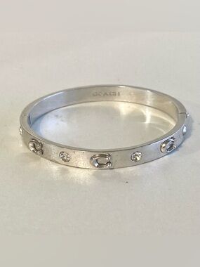 Coach Silver-Tone Crystal Accent Logo Bangle Bracelet